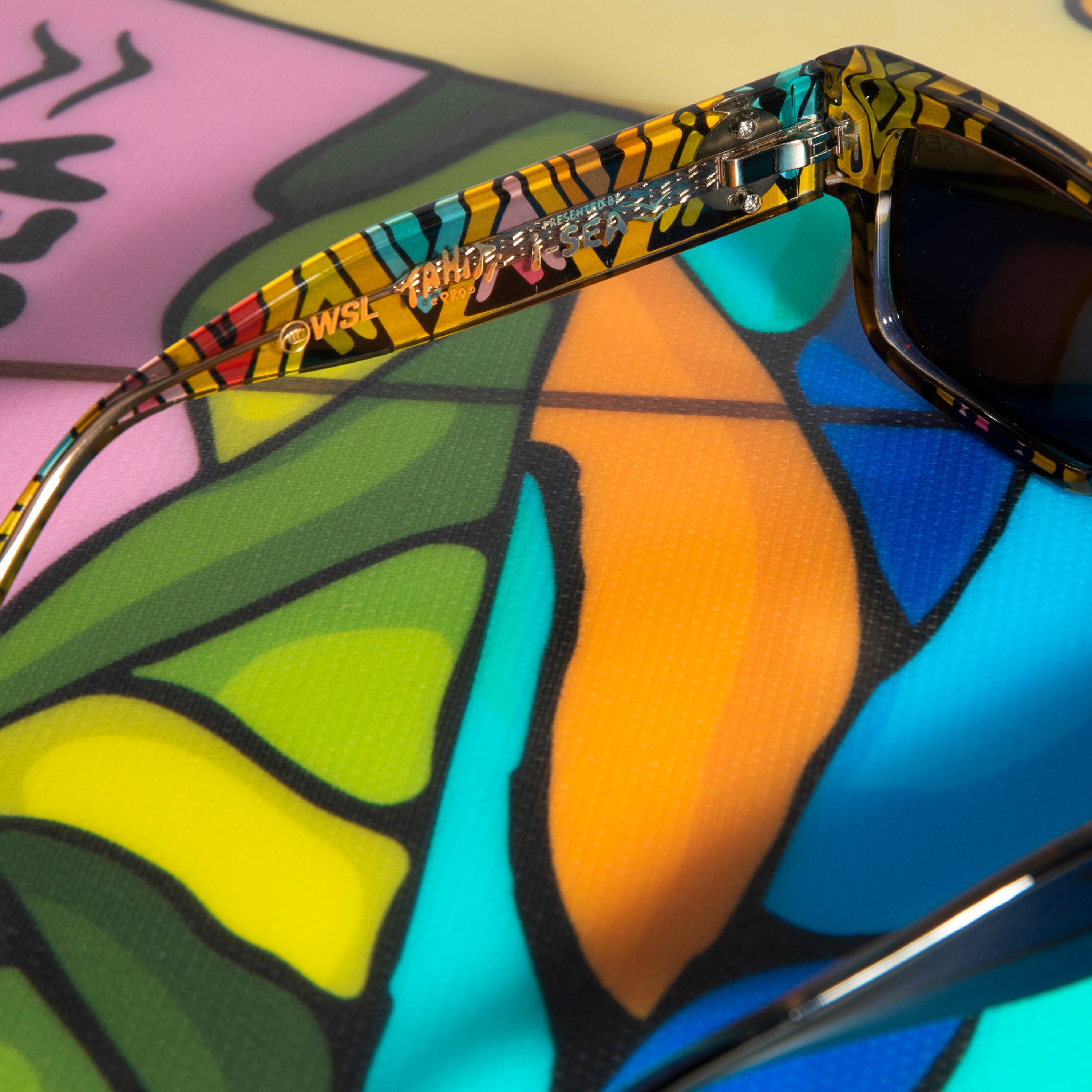 Colorful sunglasses with a patterned frame on a multicolored abstract background.
TAHITI PRO / SMOKE POLARIZED LENS