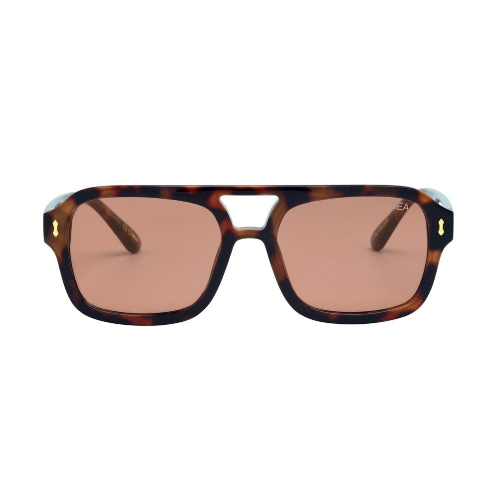 Sunglasses with tortoiseshell frame and brown lenses on a white background.
TORT / PEACH LENS