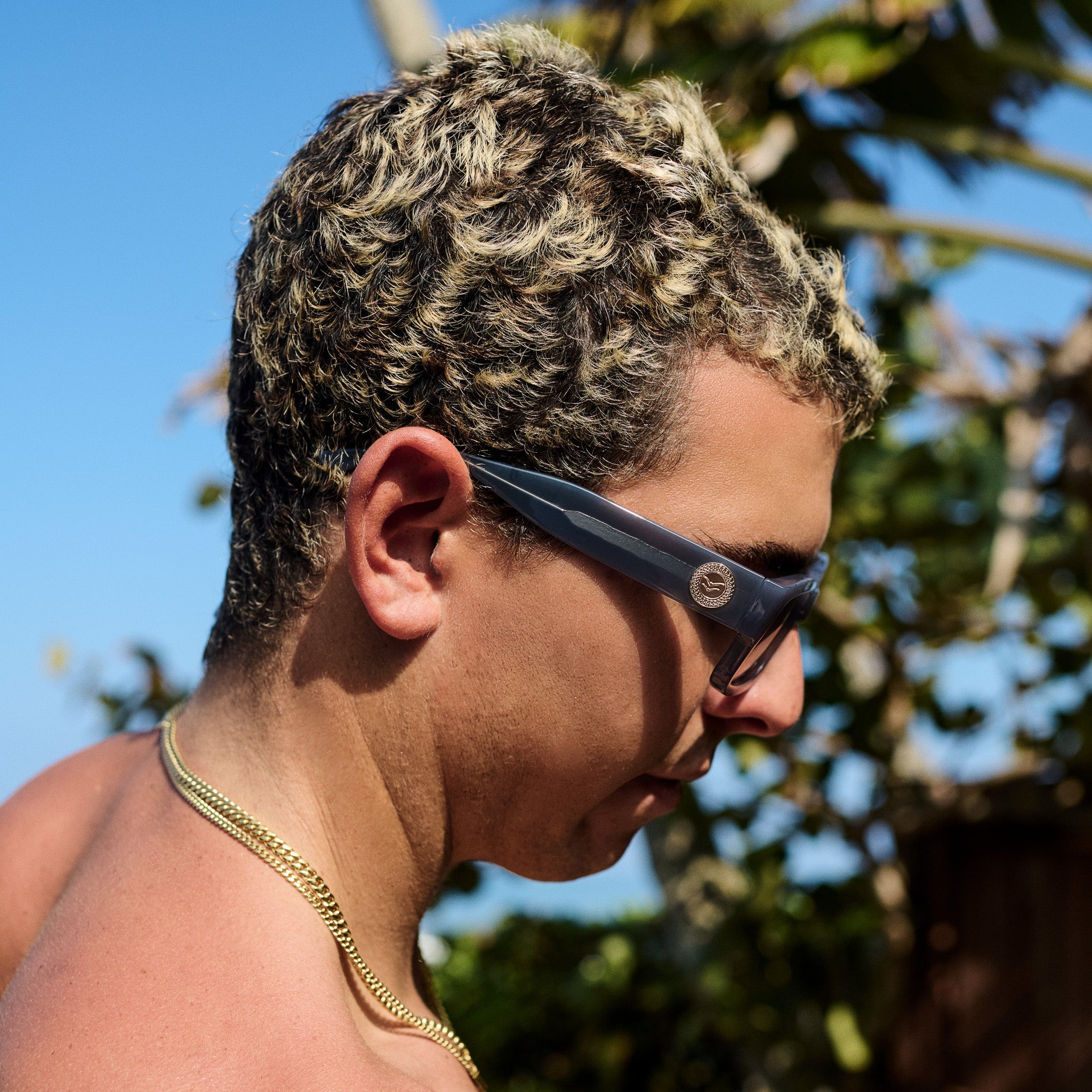 Person wearing sunglasses with a blurred natural background.
GREY / SMOKE POLARIZED LENS