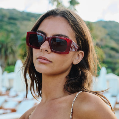 Woman wearing red sunglasses with a blurred natural background.
RASPBERRY / PLUM POLARIZED LENS