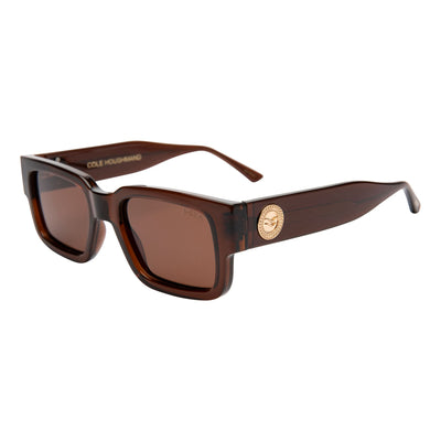 Brown sunglasses with a gold emblem on a white background.
TAUPE / BROWN POLARIZED LENS