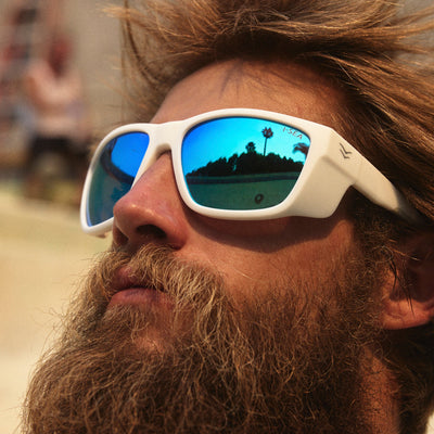 Man with a beard wearing reflective sunglasses with a blurred background.
WHITE RUBBER / BLUE MIRROR POLARIZED LENS
