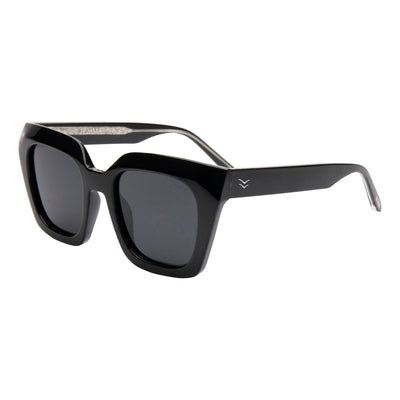 Black sunglasses with gold logo on a white background.
INK / SMOKE POLARIZED LENS