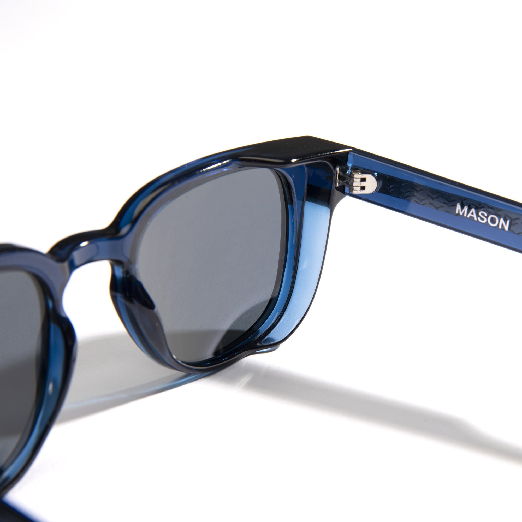 Blue sunglasses with 'MASON' branding on a white background.
DARK SEAS / SMOKE POLARIZED LENS